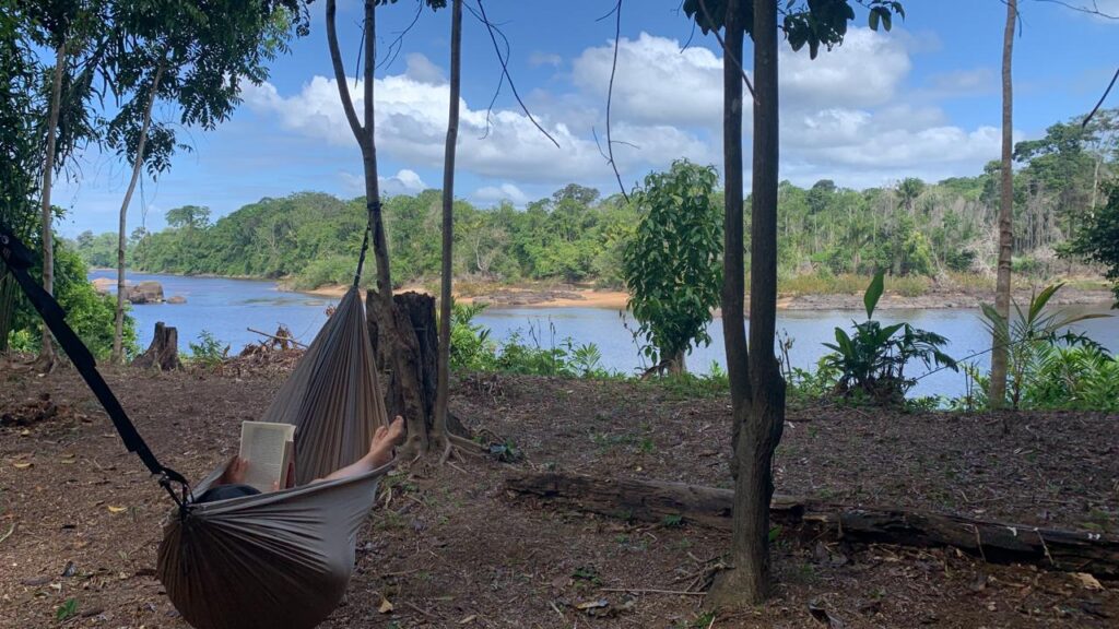 Someone Reading a Book in a Hammock